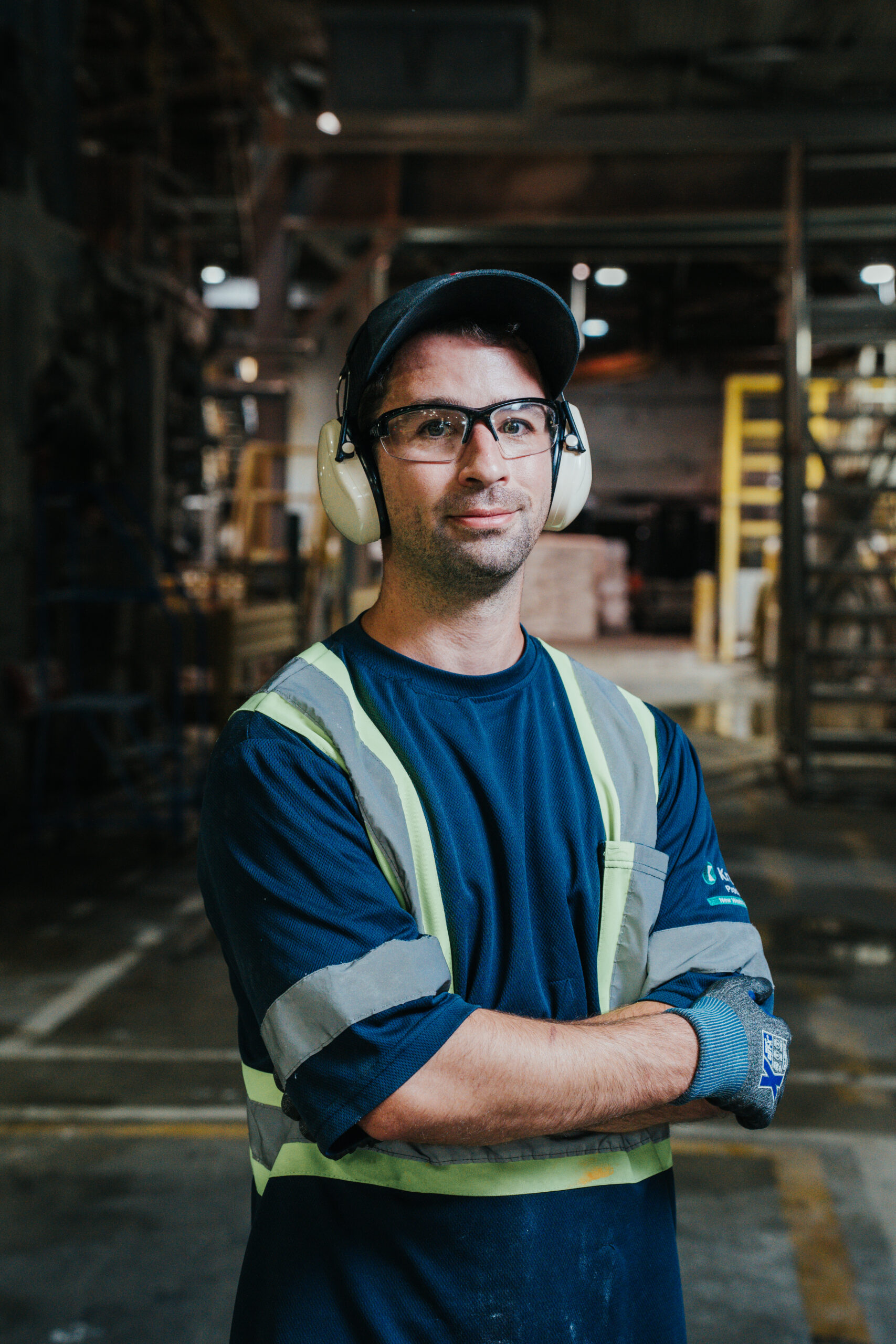 creativebyamy-krugerproducts-employees-7400198 Man poses to camera at paper machine.