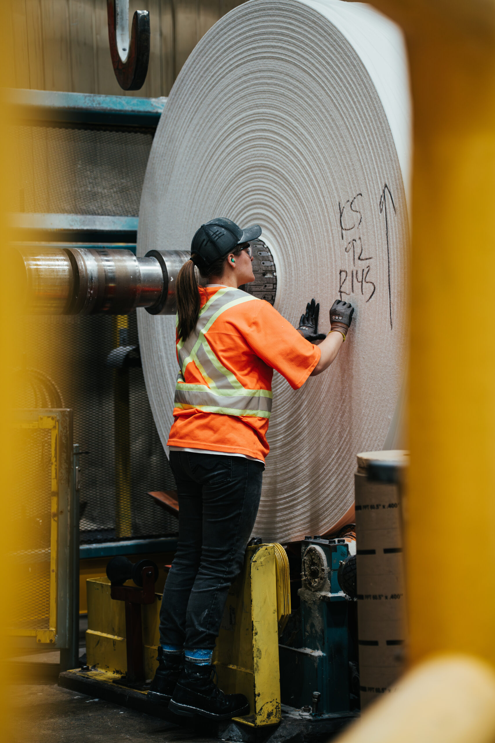 creativebyamy-krugerproducts-employees-7400428 Employee writing on giant paper roll.